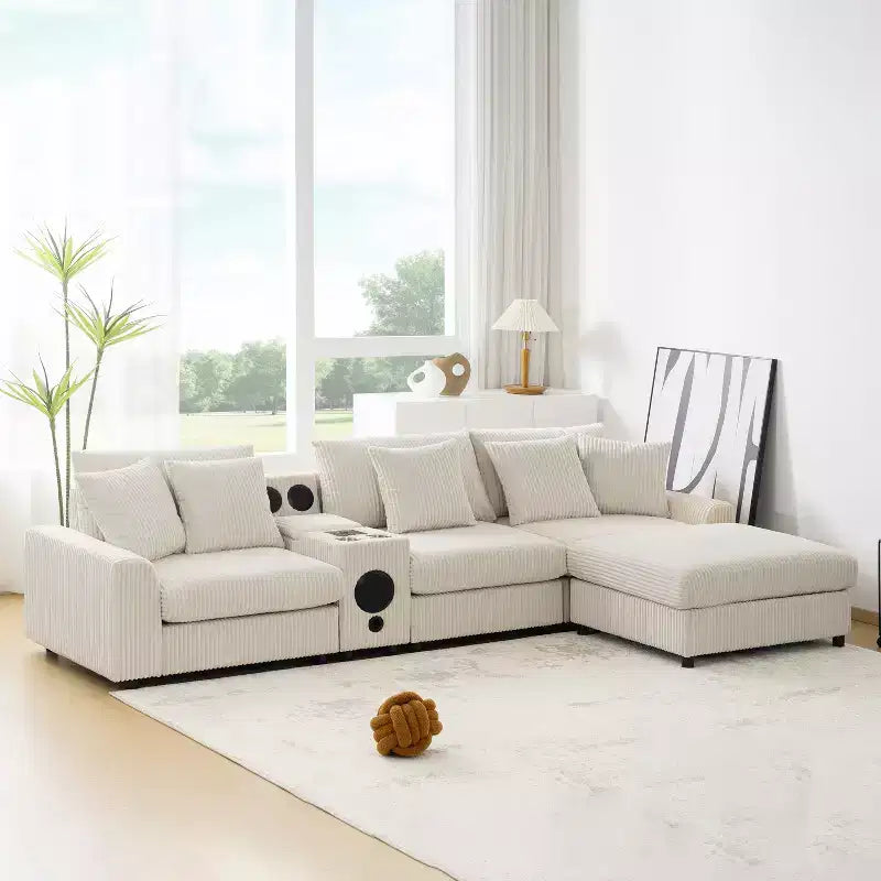Divano componibile a L in velluto a coste da 114'' con altoparlanti Bluetooth, caricabatterie USB, portabicchieri e pouf - ModernLuxe