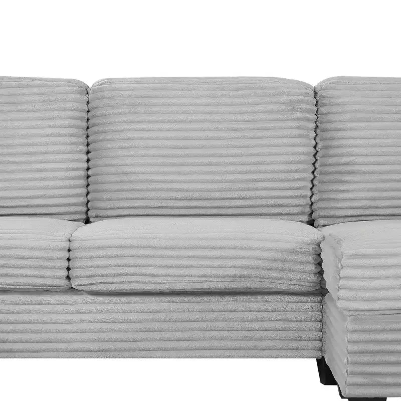 Divano sezionale Whisen in velluto a coste con pouf mobile e tasche laterali portaoggetti