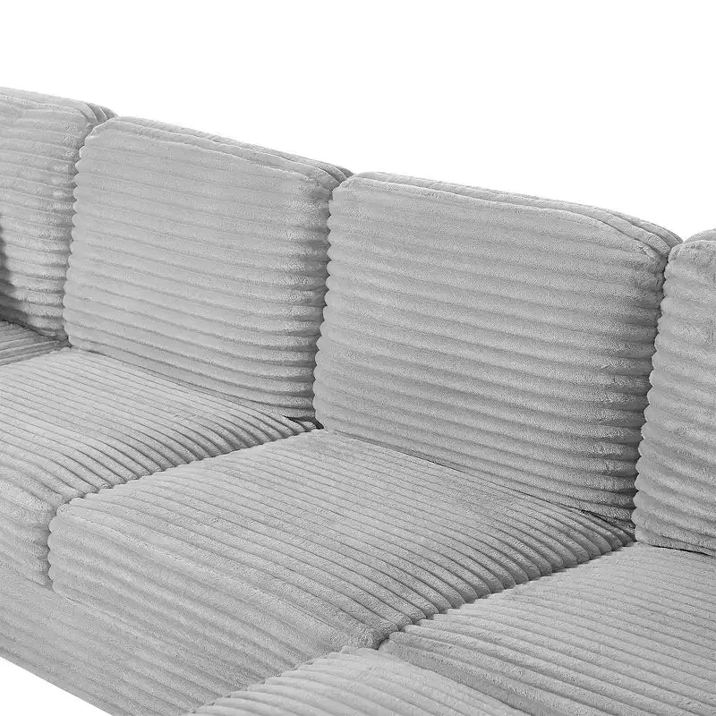 Divano sezionale Whisen in velluto a coste con pouf mobile e tasche laterali portaoggetti
