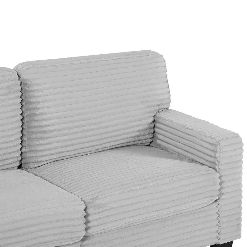 Divano sezionale Whisen in velluto a coste con pouf mobile e tasche laterali portaoggetti
