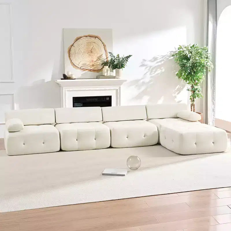 Divano sezionale in velluto a forma di L Mjkone, divano componibile a 4 posti con pouf, divani trasformabili con bordo borchiato