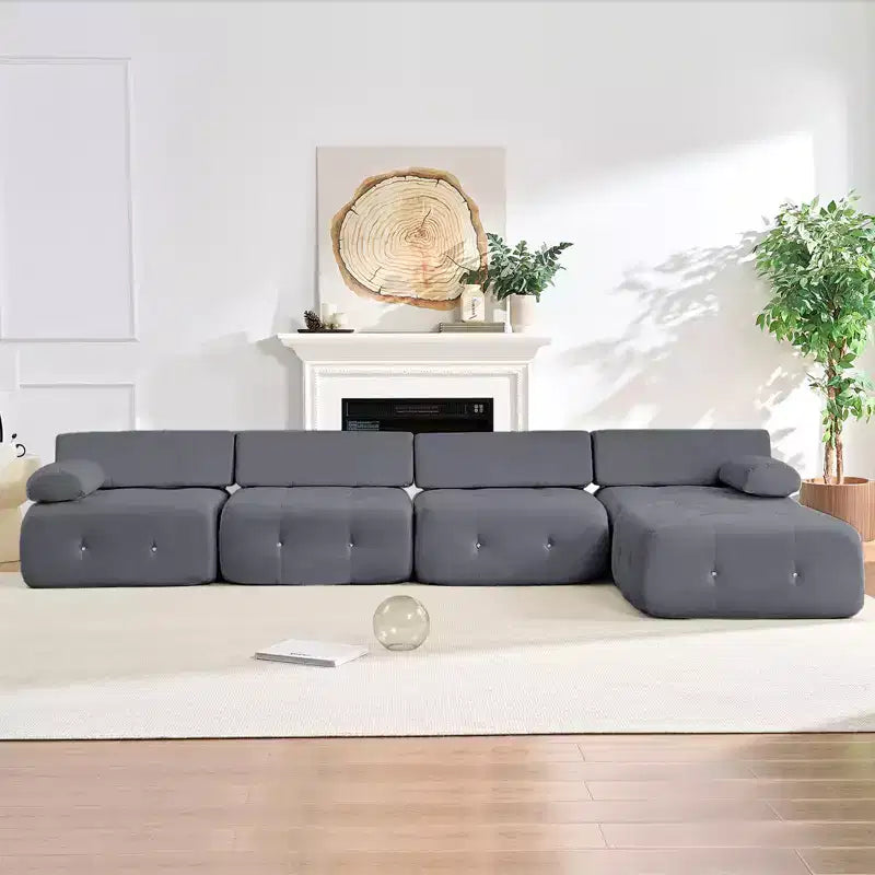 Divano sezionale in velluto a forma di L Mjkone, divano componibile a 4 posti con pouf, divani trasformabili con bordo borchiato